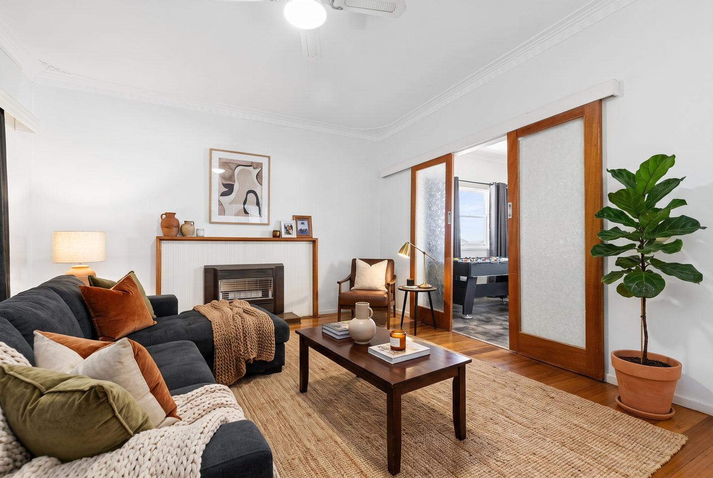Separate lounge with polished timber floors and timber-framed sliding doors